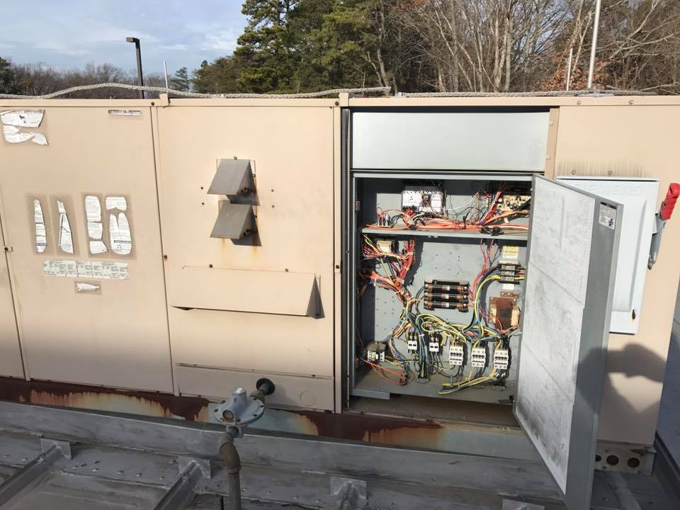 A Large Industrial Air Conditioning Unit Surrounded By Numerous Wires