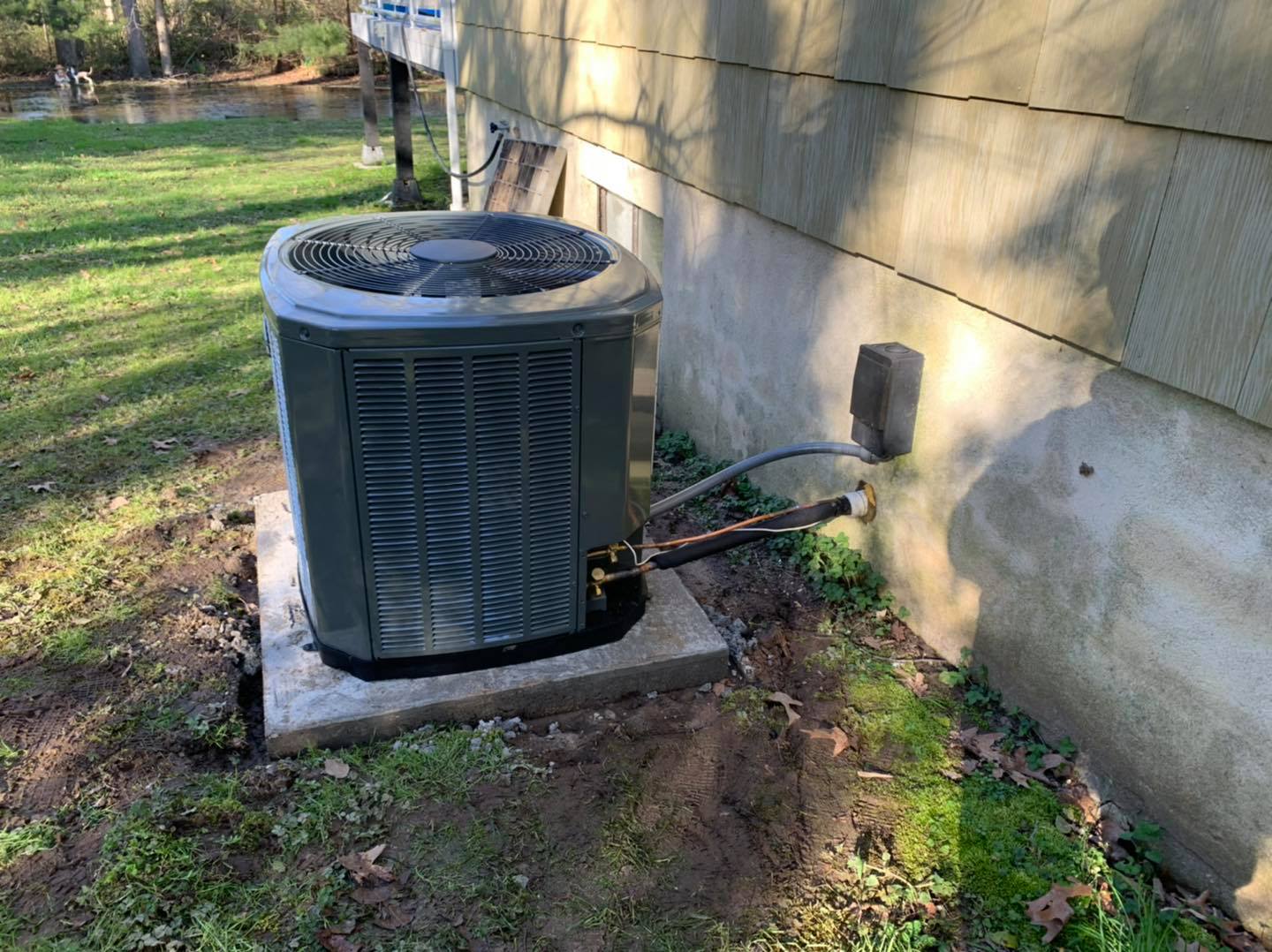 A Heat Pump Installed In Front Of A Residential House