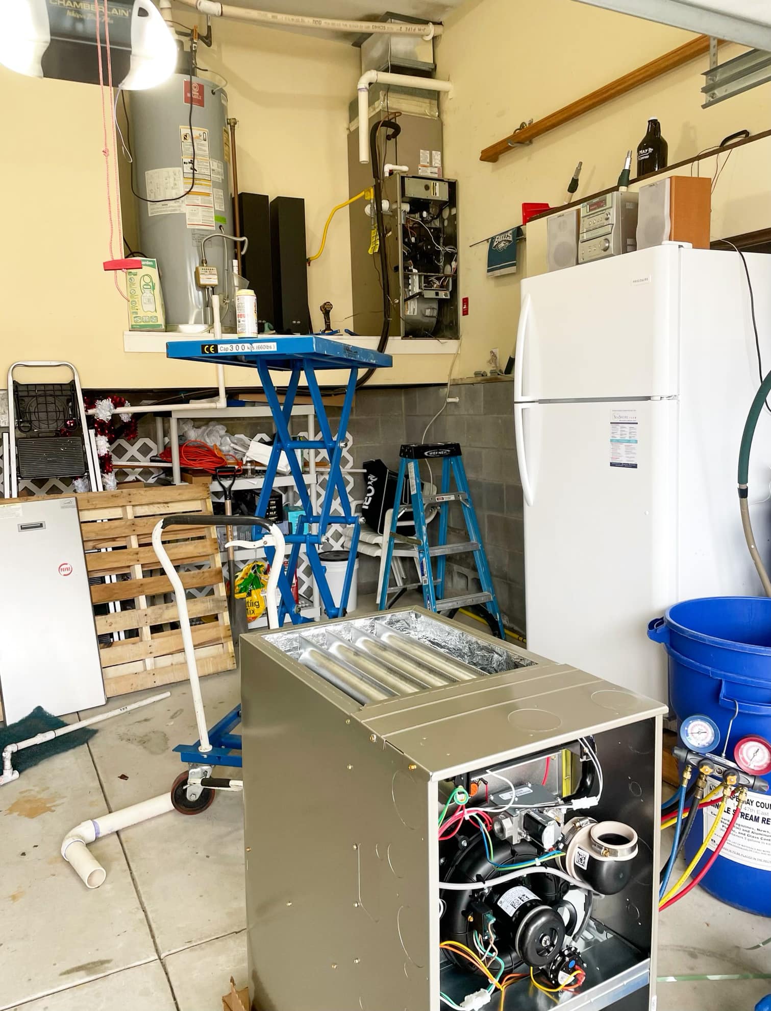 A Garage Interior Featuring A Refrigerator